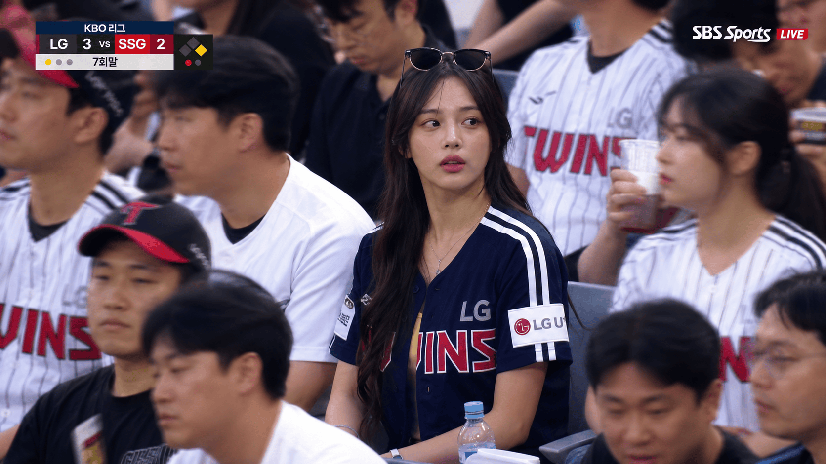Korean baseball live broadcast fan cam framing with scoreboard and crowd